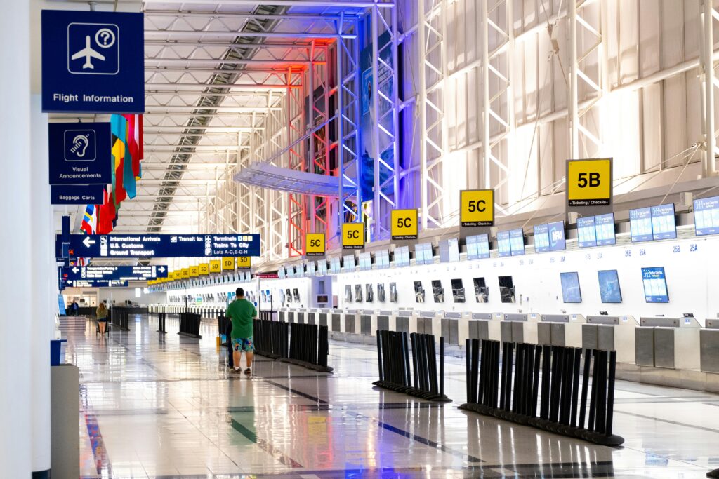 airport ground staff assisting passengers at a busy airport in the USA
