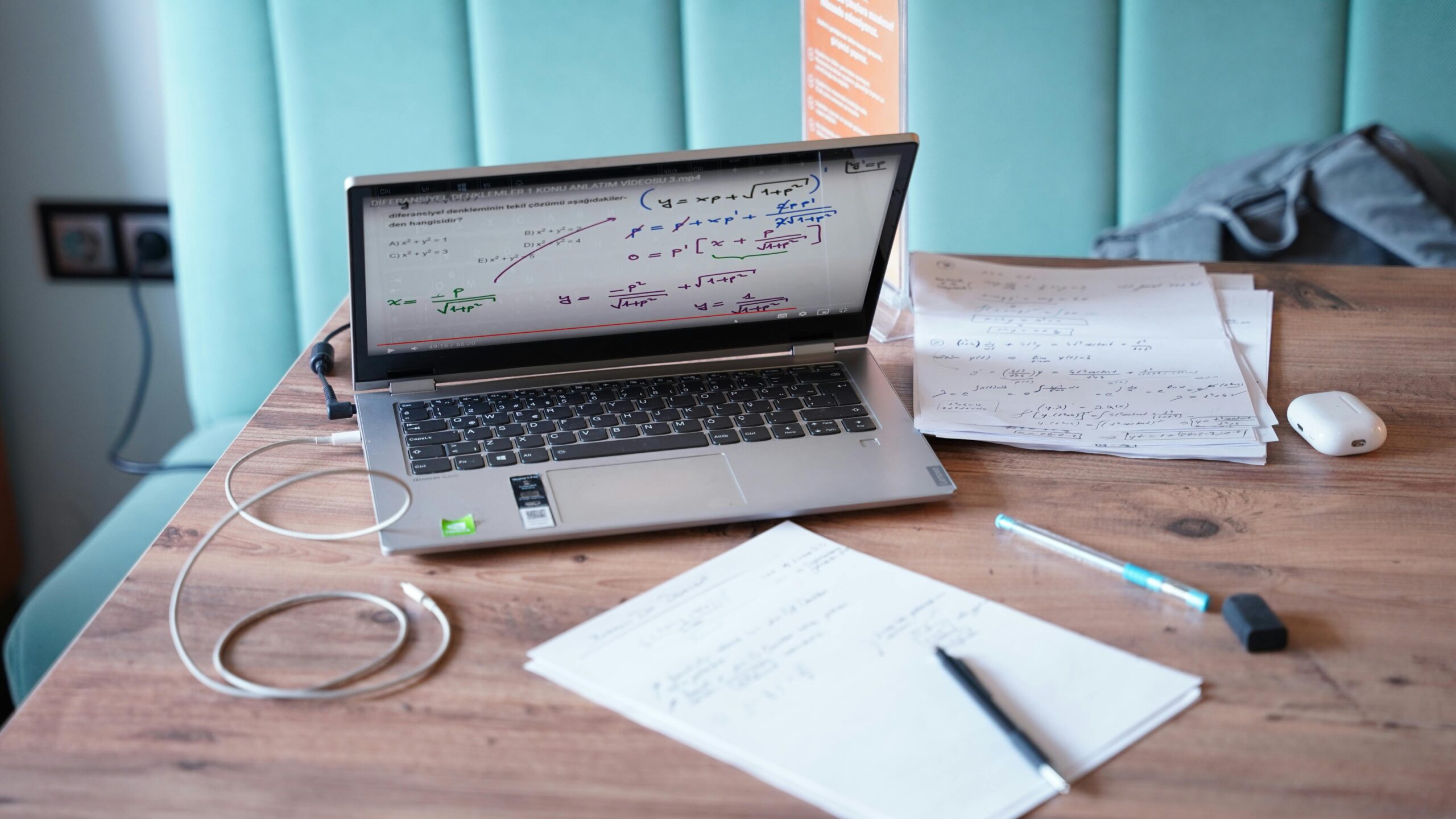Candidate preparing for technical interview by studying skills and practicing problem-solving questions on laptop