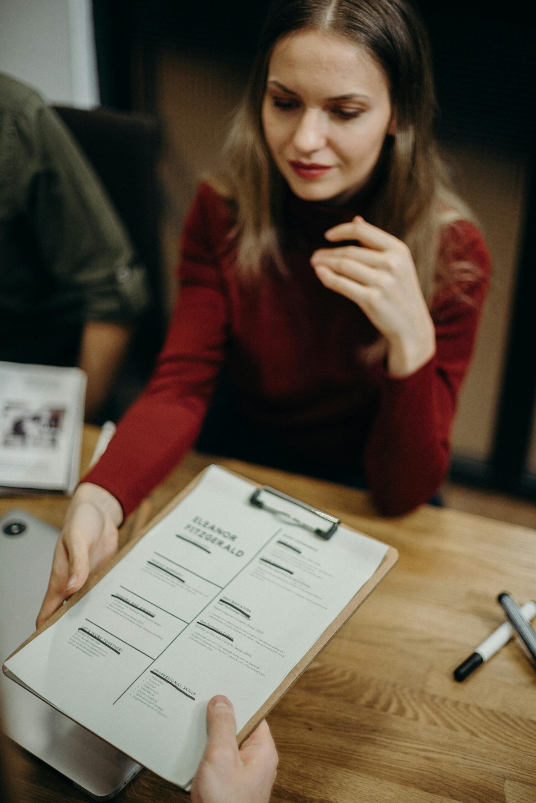 Job seeker carefully reviewing resume and online job application before submission