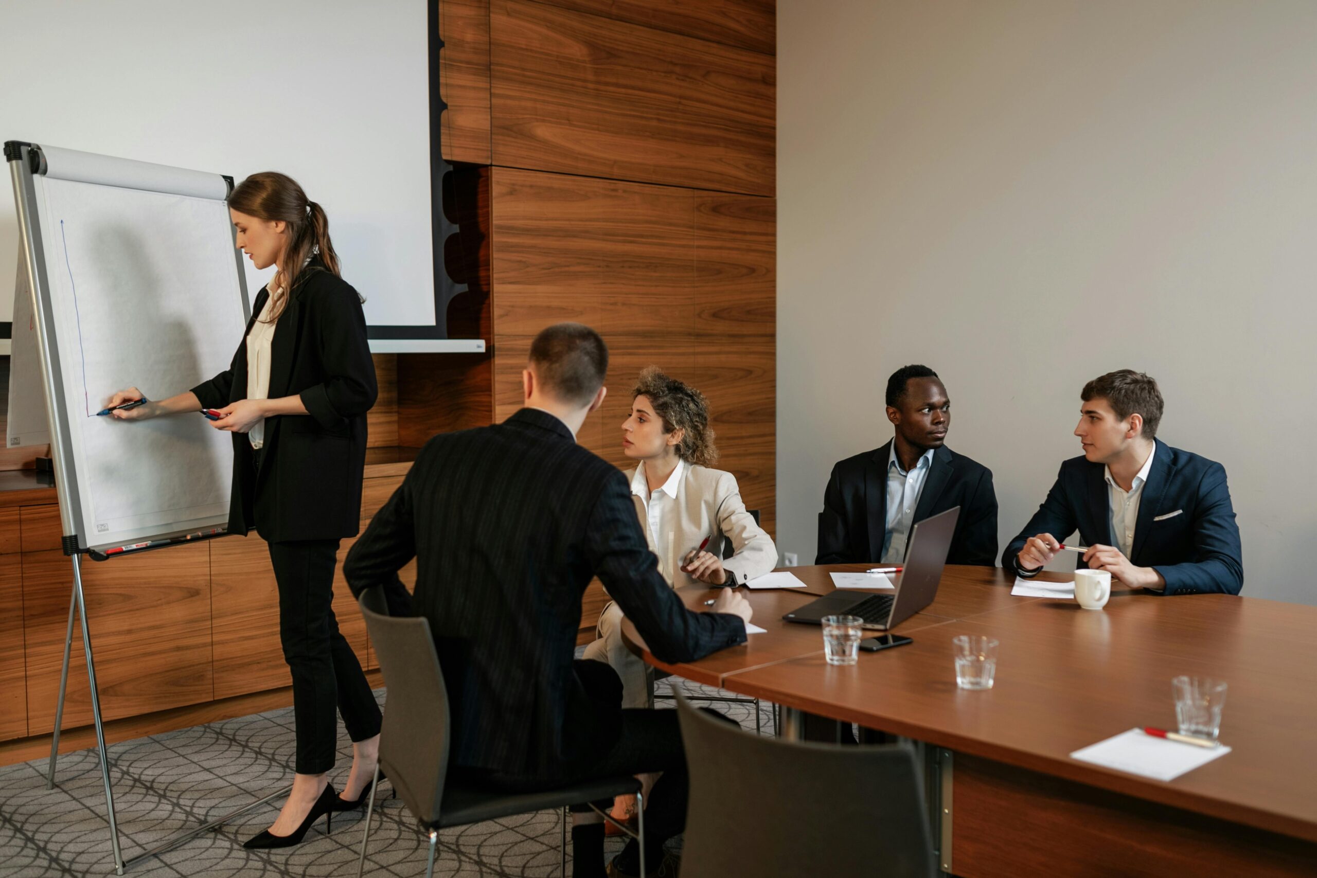 Professional team discussing workplace soft skills and career growth in office meeting