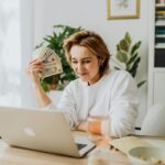 Freelancer smiling after receiving first ten dollar online payment from a completed freelance project