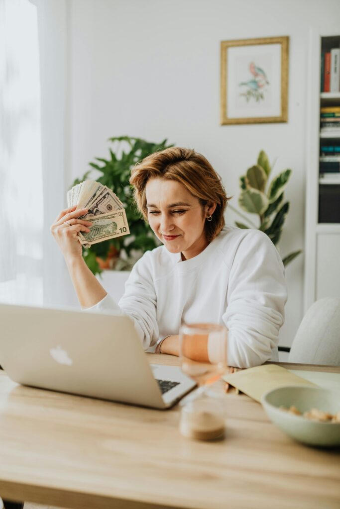 Freelancer smiling after receiving first ten dollar online payment from a completed freelance project