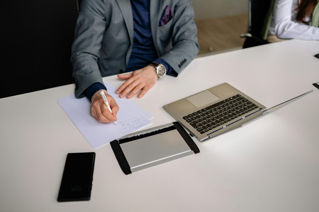 Job candidate building confidence before interview while preparing professionally with notes and laptop