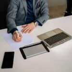 Job candidate building confidence before interview while preparing professionally with notes and laptop