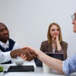Job candidate answering common HR interview questions confidently during professional interview meeting
