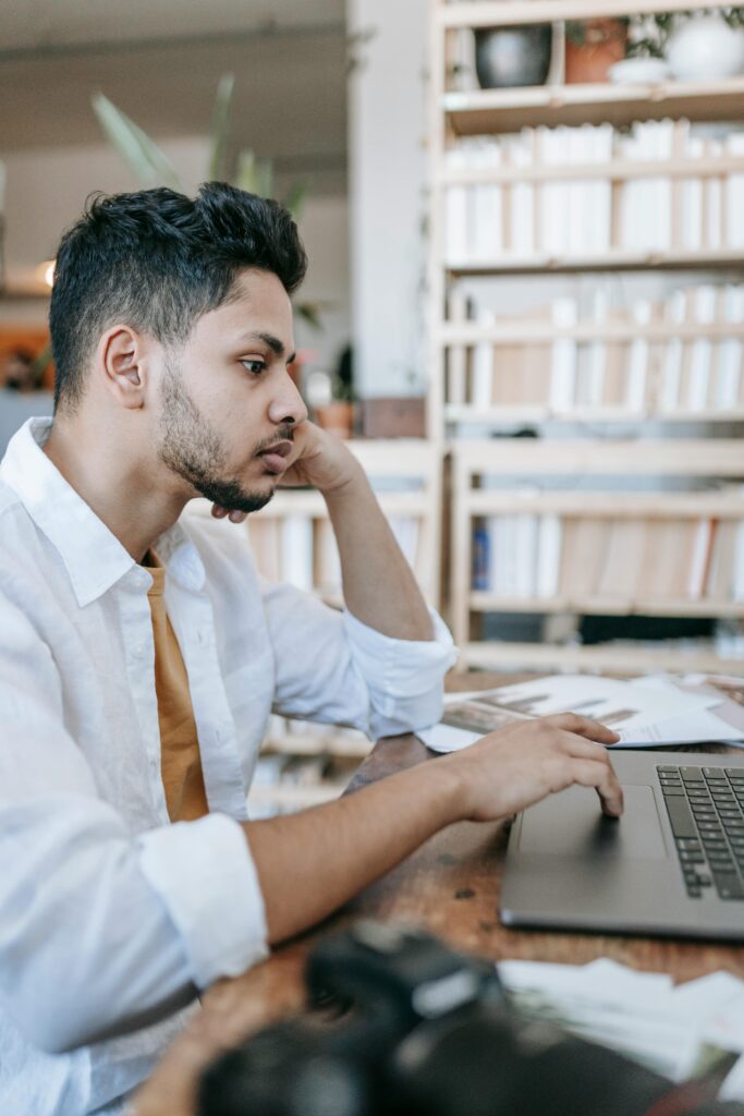 Student working on first freelance project from home while communicating with online client
