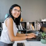 Successful professional following productive daily habits while working on laptop in modern workspace