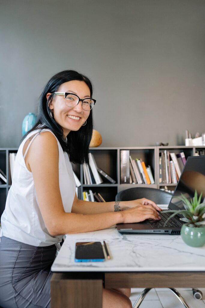 Successful professional following productive daily habits while working on laptop in modern workspace